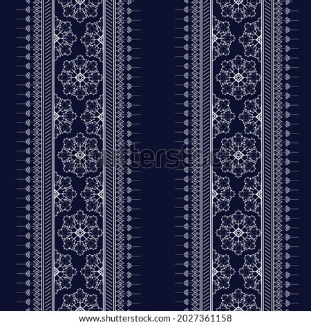 Geometric ethnic texture embroidery with Dark Blue background, wallpaper,skirt,carpet,wallpaper,clothing,wrapping,Batik,fabric,sheet, texture Flowers pattern in Vector, illustration style.eps