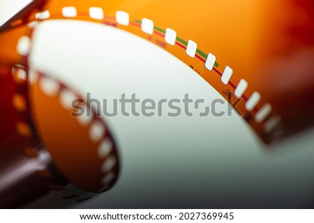 Photographic film negative rolled up roll on a light background. Web banner.
