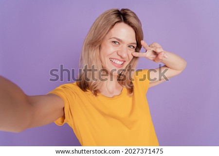 Close up photo beautiful woman happy positive smile make take selfies show peace cool v-sing isolated over purple color background