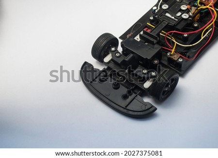 a broken remote control toy car, only some of the engine components remain