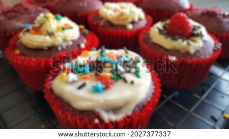Blurry vision view of home made bakery, gluten free mini cupcake with fun decoration with cream cheese and colorful sprinkles on the top. Home party, kid afternoon healthy snack.