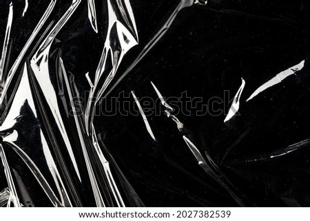 Wrinkled plastic wrap texture on a black background wallpaper