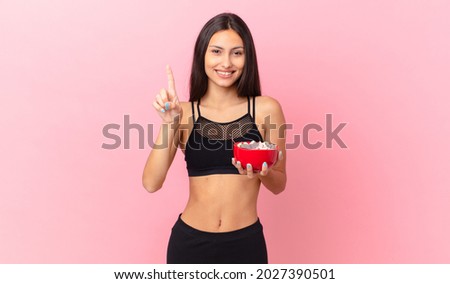 pretty hispanic woman with a diet breakfast bowl