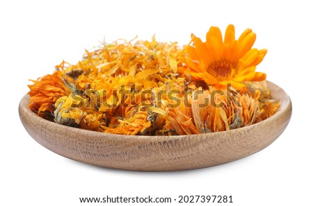 Wooden plate with dry and fresh calendula flowers on white background