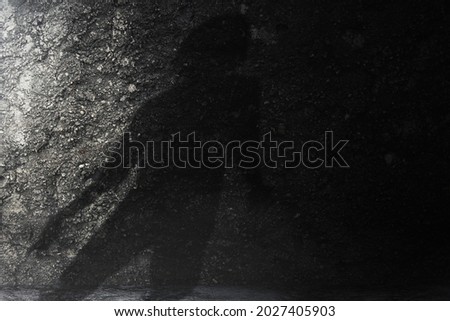Silhouette of zombie with grunge wall background