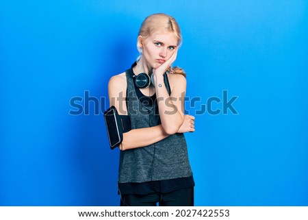 Beautiful caucasian woman with blond hair wearing sportswear thinking looking tired and bored with depression problems with crossed arms. 