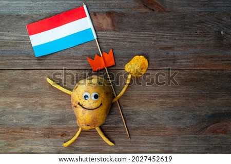 Koningsdag or Kings Day is a national holiday in the Kingdom of the Netherlands. Funny potato with eyes and mouth holding the flag of the Netherlands