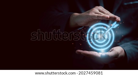 Businessman gesture protecting virtual blue dartboard with arrow ,Business Achievement objective target concept. Royalty-Free Stock Photo #2027459081