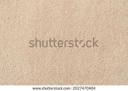 Beige  curly wool seamless texture background. texture with short factory material.