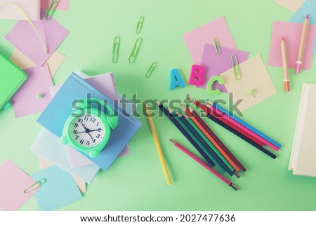 Books and stationery on bright background, top view, flat ley, back to school concept, education