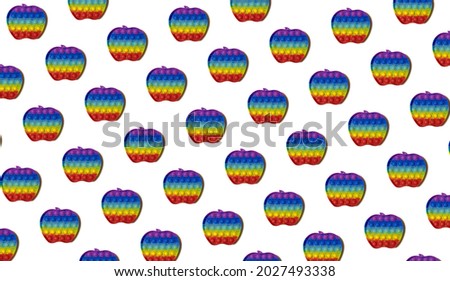 Background for design and banners. Children's rubber toy in the shape of a rainbow apple on a white background. Pattern
