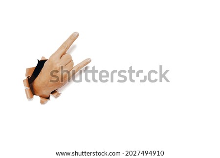 Hand showing a heavy metal or rock and roll sign. Isolated on white with copy space.