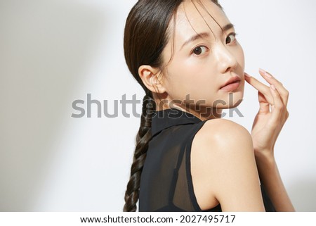 Beauty portrait of a young Asian woman in a black dress Royalty-Free Stock Photo #2027495717
