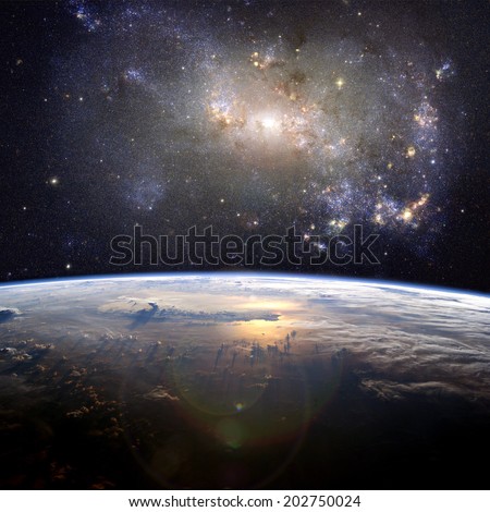 A beautiful nebula (the irregular galaxy, NGC 4449) over the Earth. Elements of this image furnished by NASA.  Royalty-Free Stock Photo #202750024