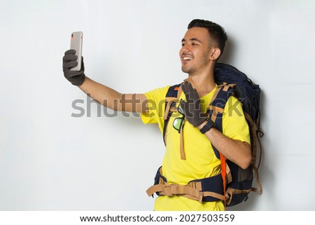Young handsome hiker man using mobile phone isolated on white background