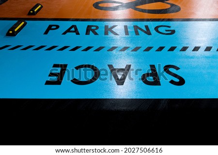 Word parking space on parking garage floor.