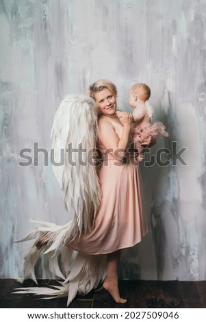 Angel mom with wings and angel daughter with wings