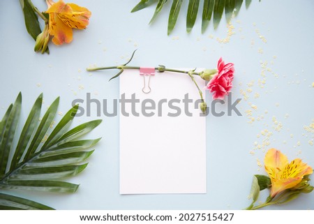 Festive postcard mock up on blue background with alstroemeria and aistra flowers. Top view. 1st of September and back to school mock up concept. High quality photo