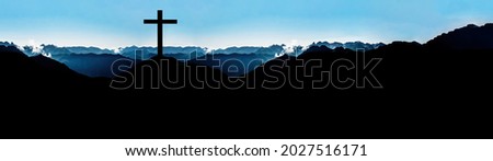 Religious grief landscape background banner panorama - View with black silhouette of mountains, hills, forest and cross summit cross, in the evening during the sunset, with blue colored sky	