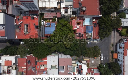 Aerial view of solar panels mounted on the roof of a two houses located in Mexico City, Mexico.