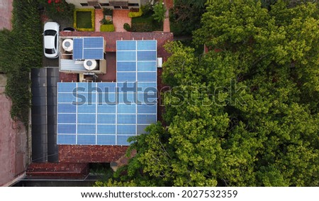 Aerial view of a solar panel mounted on the roof of a house located in Mexico City, Mexico. Royalty-Free Stock Photo #2027532359