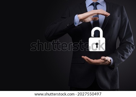 Businessman holds an open padlock icon on his palm.unlocking a virtual lock. Business concept and technology metaphor for cyber attack, computer crime, information security and data encryption