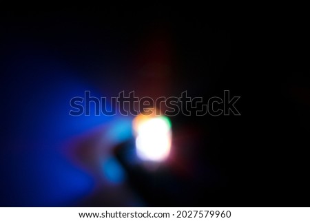 Blur photo of light spectrum from two cubic prisms in dark room for background usage