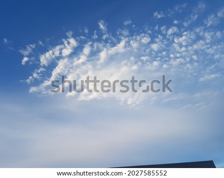 Deep blue sky with cloud ridges forming