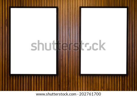 2 blank paper frames on wooden wall