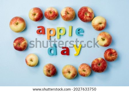 Apple is a national holiday on October 21. Red apples on a blue background. Flat lay.