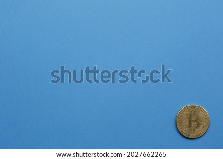 Gold bitcoin on blue background