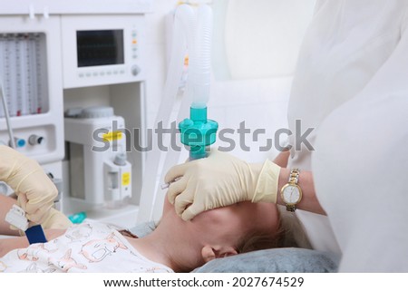 Intubation of the trachea. The child is connected to a ventilator. Preparing for surgery. General anesthesia for the child.