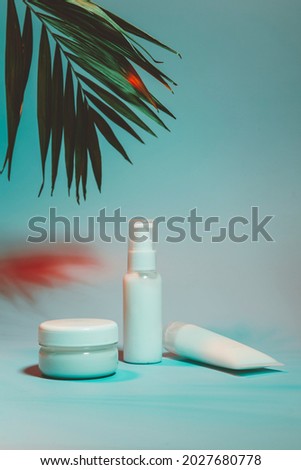 white bottles of cosmetics in neon