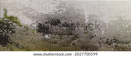 View of nature and the sky through a mosquito net soaked with water
