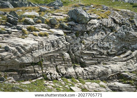 Characteristic appearance of a metamorphic rock derived from the exaggerated deformation of sandstone Royalty-Free Stock Photo #2027705771