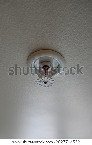 Common Types of Fire Sprinkler System on the white ceiling in the apartment, sensor action when the smoke detected.