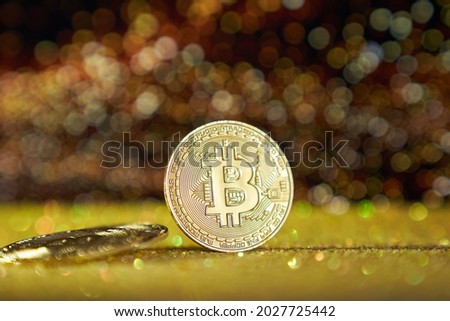 Cryptocurrency bitcoin is the coin of the future. Golden Bitcoin. Gold shiny background. High quality photo