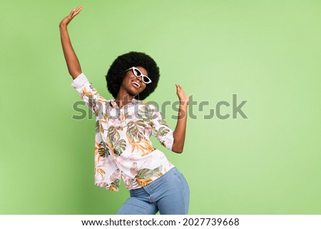 Portrait of attractive girlish carefree cheerful girl dancing having fun isolated over green pastel color background Royalty-Free Stock Photo #2027739668