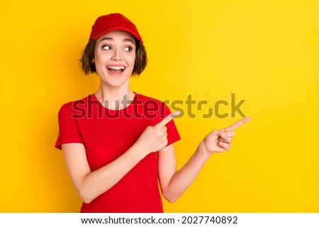 Photo of nice impressed brown hair lady point empty space wear t-shirt cap isolated on yellow color background