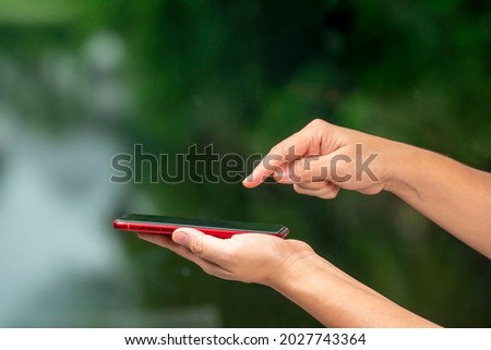 Woman Hand hands holding smart phone blur nature background, people use smart phone for contact education, online marketing, business, online technology.