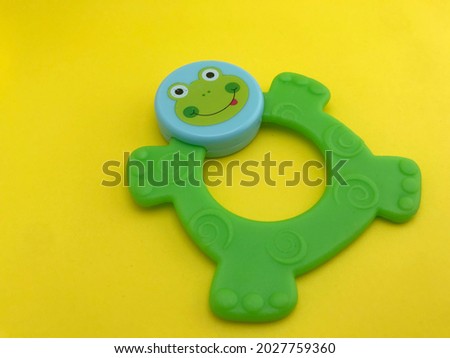 Baby theeter with frog concept on yellow background