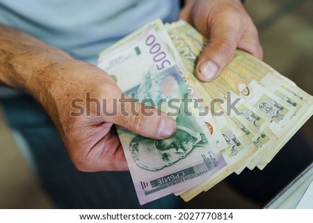 Top view close up on hand of unknown caucasian man holding and counting money serbian dinar RSD banknotes Royalty-Free Stock Photo #2027770814