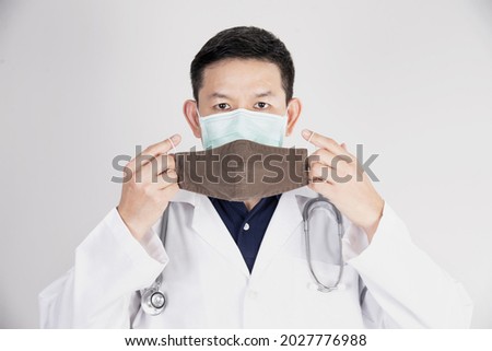 Asian doctor is wearing double layer masks for protecting Covid-19 virus - medical people working concept