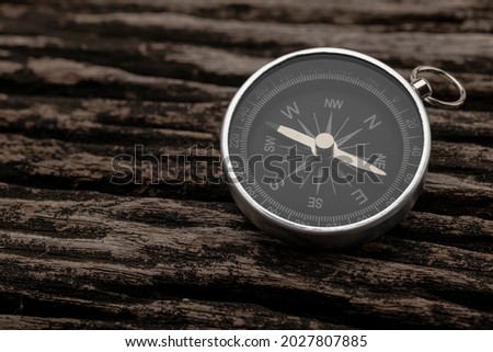 Compass, navigational compass on wooden background 