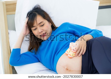 Beautiful lovely mother pregnant woman relax on bed at home