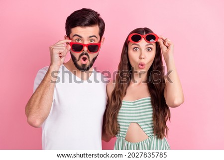 Photo of amazed surprised couple open mouth take off sunglass wait wear casual outfit isolated pink color background