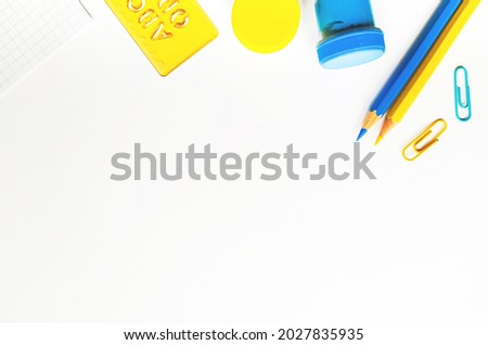 















Yellow and blue stationery on white background top view. Design elements for cards, poster, banner. Back to school concept.