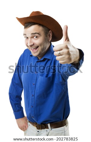 Cheerful smiling positive guy in cowboy hat showing sign thumb up finger.