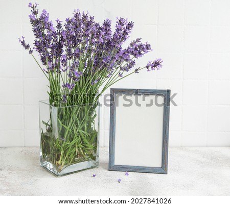 A bouquet of lavender in the interior of a kitchen. Frame mockup on a  table.