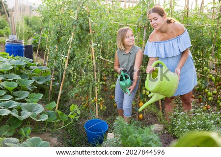 Mom and daughter spending a great time together in the garden